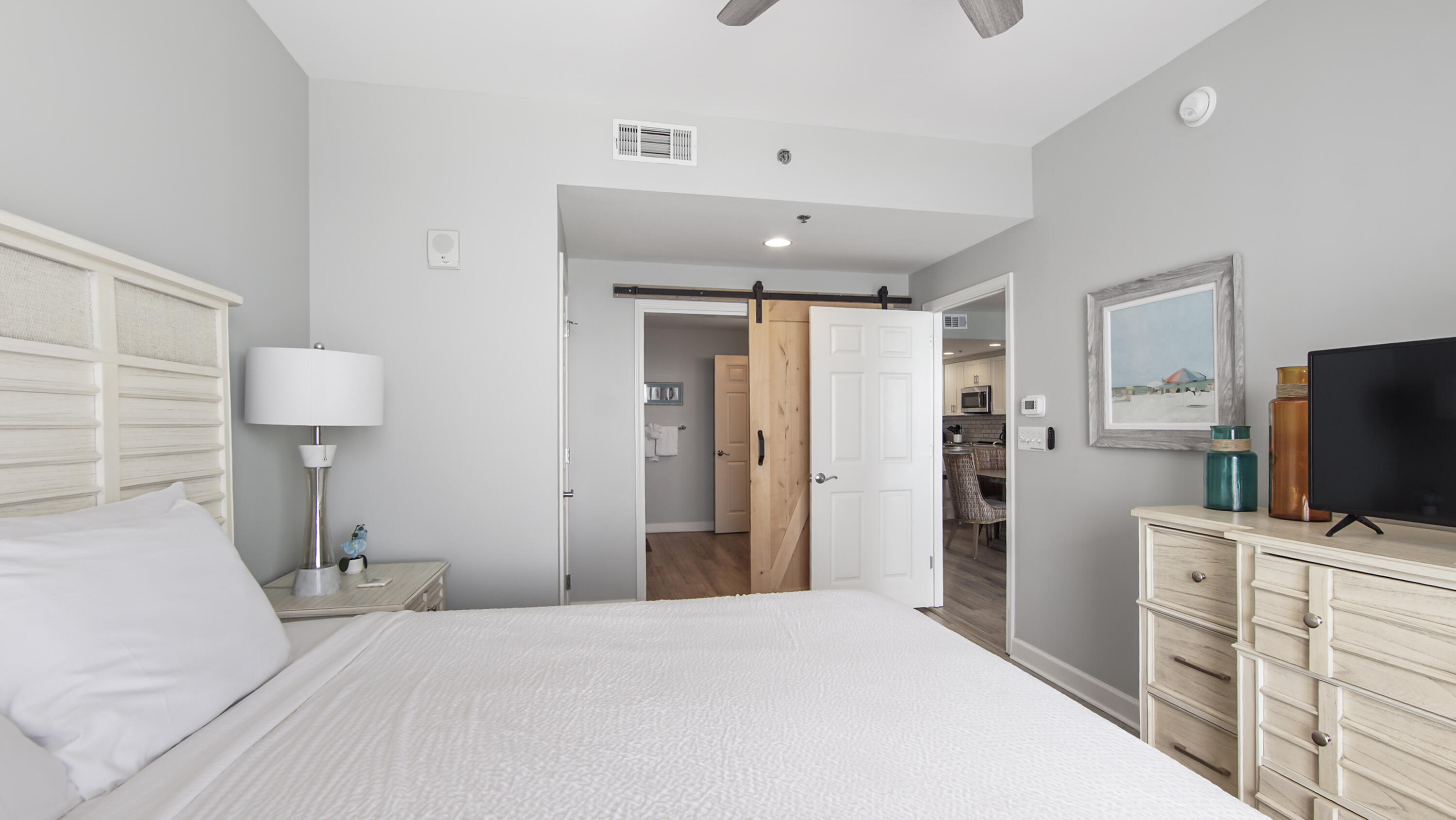 17739 Front Beach Road, Unit 507W Panama City Beach, FL 32413 - Photo 16 of 49 a bedroom with a bed and a flat screen tv in it