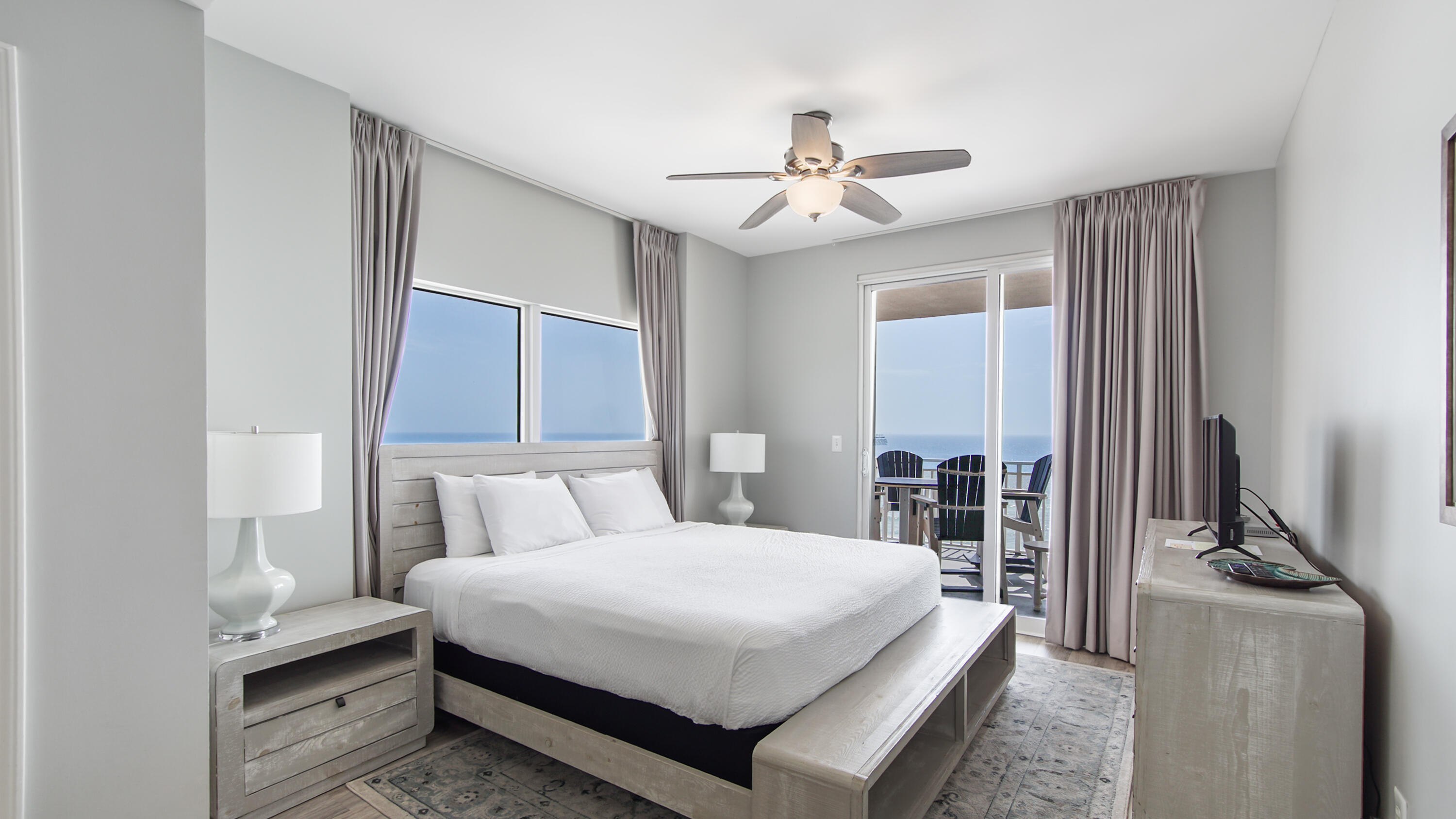 17739 Front Beach Road, Unit 507W Panama City Beach, FL 32413 - Photo 19 of 49 a bedroom with a bed and a chandelier