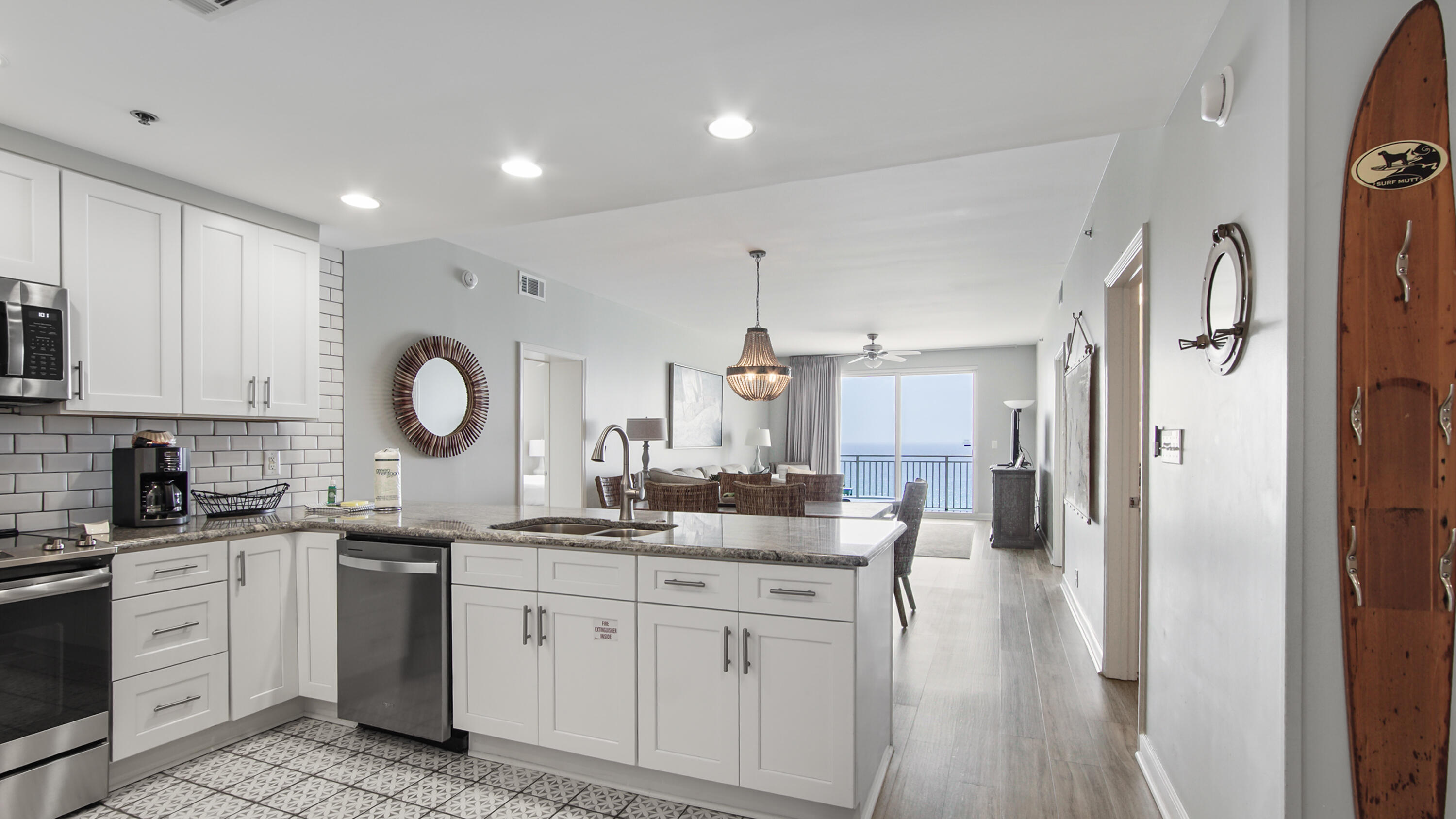 17739 Front Beach Road, Unit 507W Panama City Beach, FL 32413 - Photo 2 of 49 a kitchen with white cabinets and sink