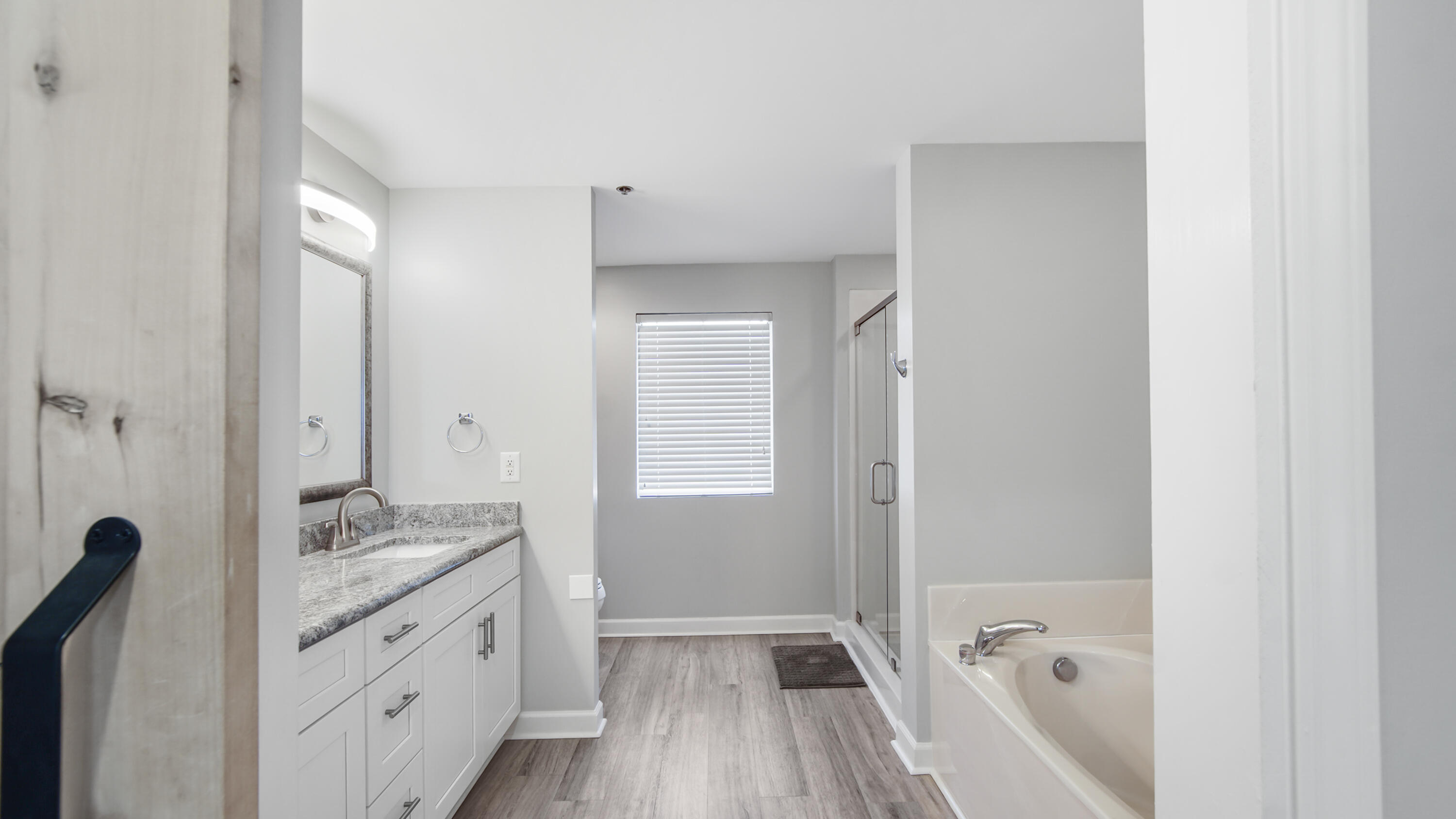 17739 Front Beach Road, Unit 507W Panama City Beach, FL 32413 - Photo 22 of 49 a bathroom with a granite countertop sink a mirror and a bathtub