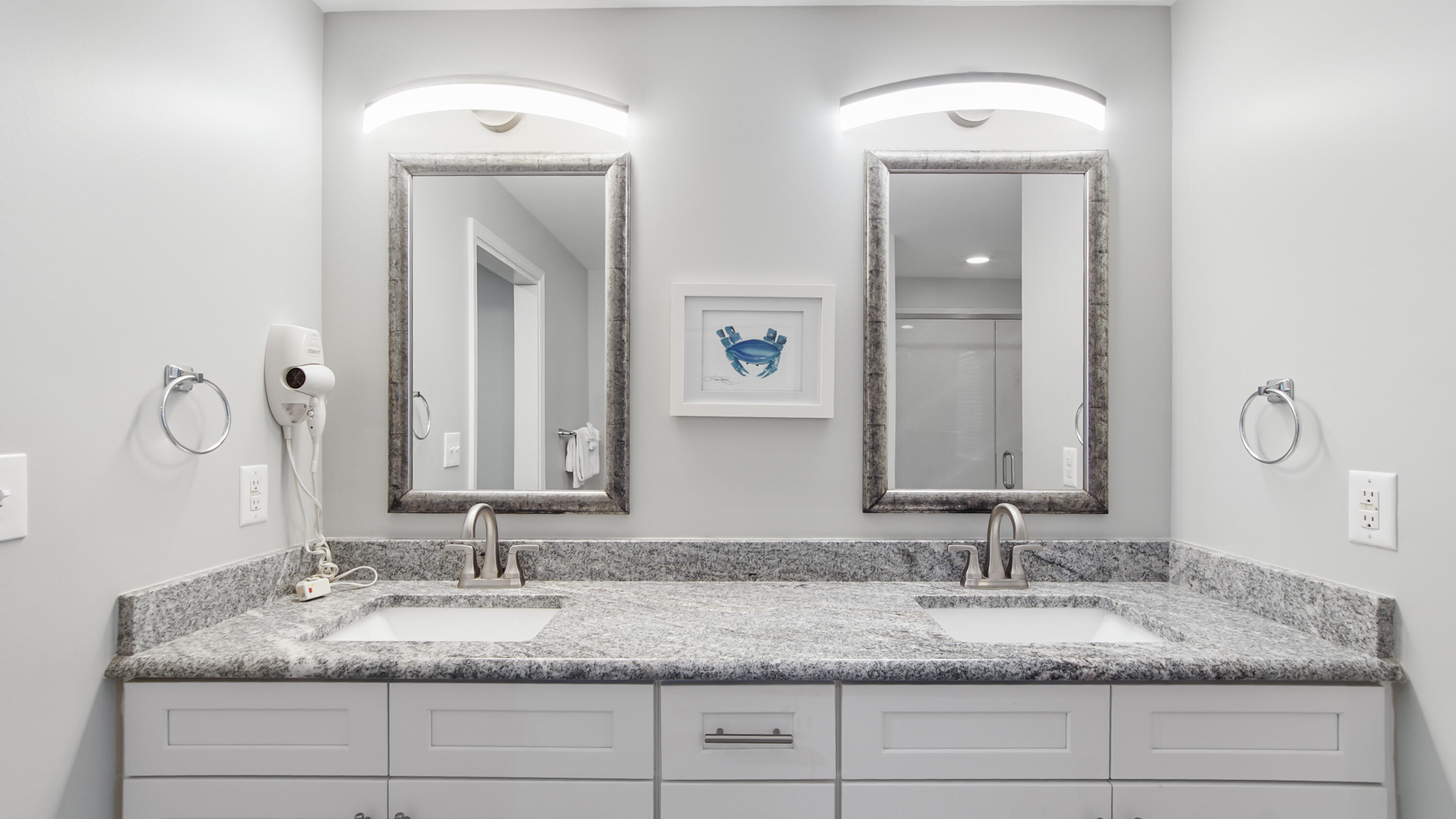 17739 Front Beach Road, Unit 507W Panama City Beach, FL 32413 - Photo 23 of 49 a bathroom with double vanity sinks granite vanity and a mirror