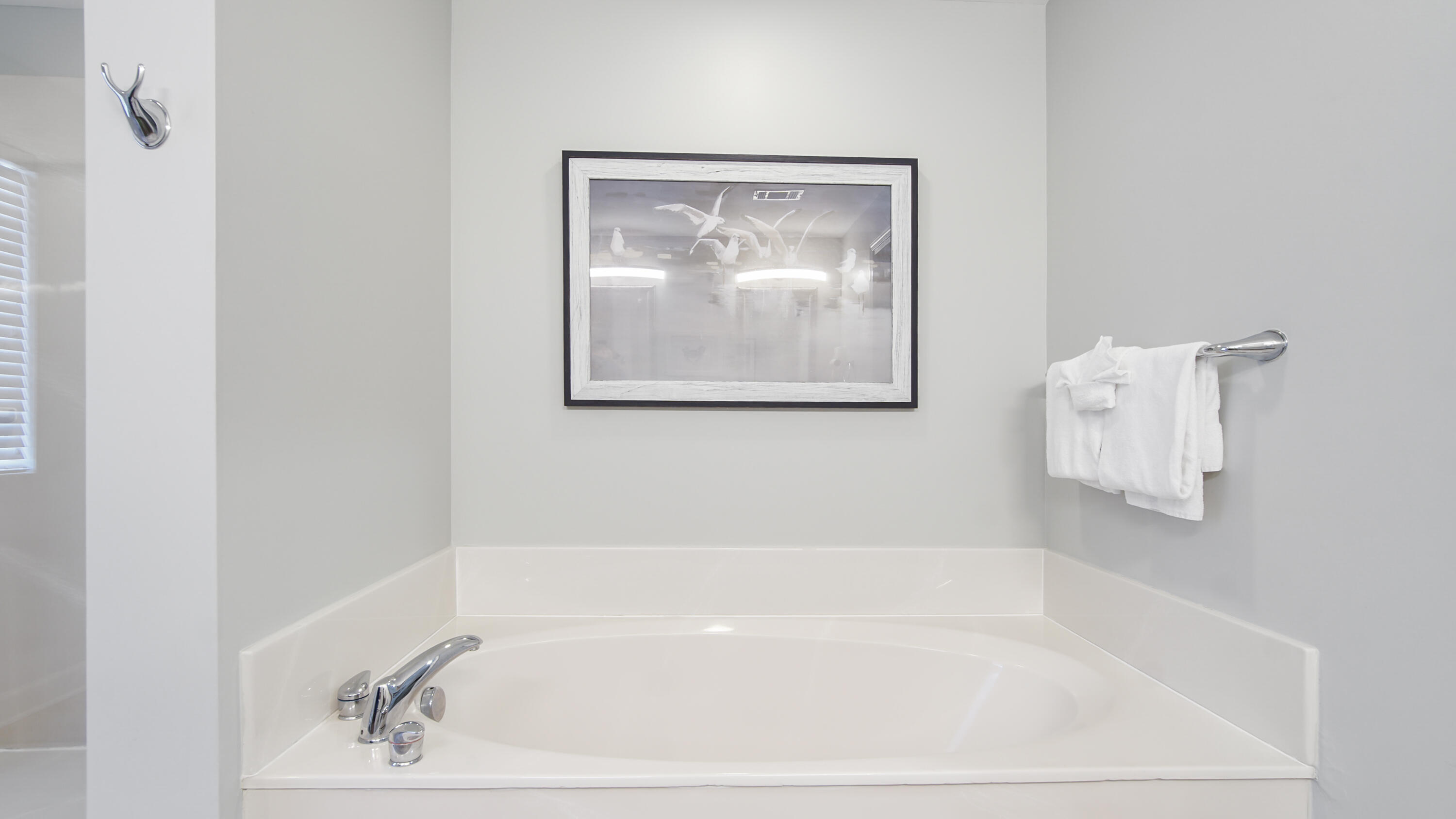 17739 Front Beach Road, Unit 507W Panama City Beach, FL 32413 - Photo 25 of 49 a white bath tub sitting next to a white sink and vanity