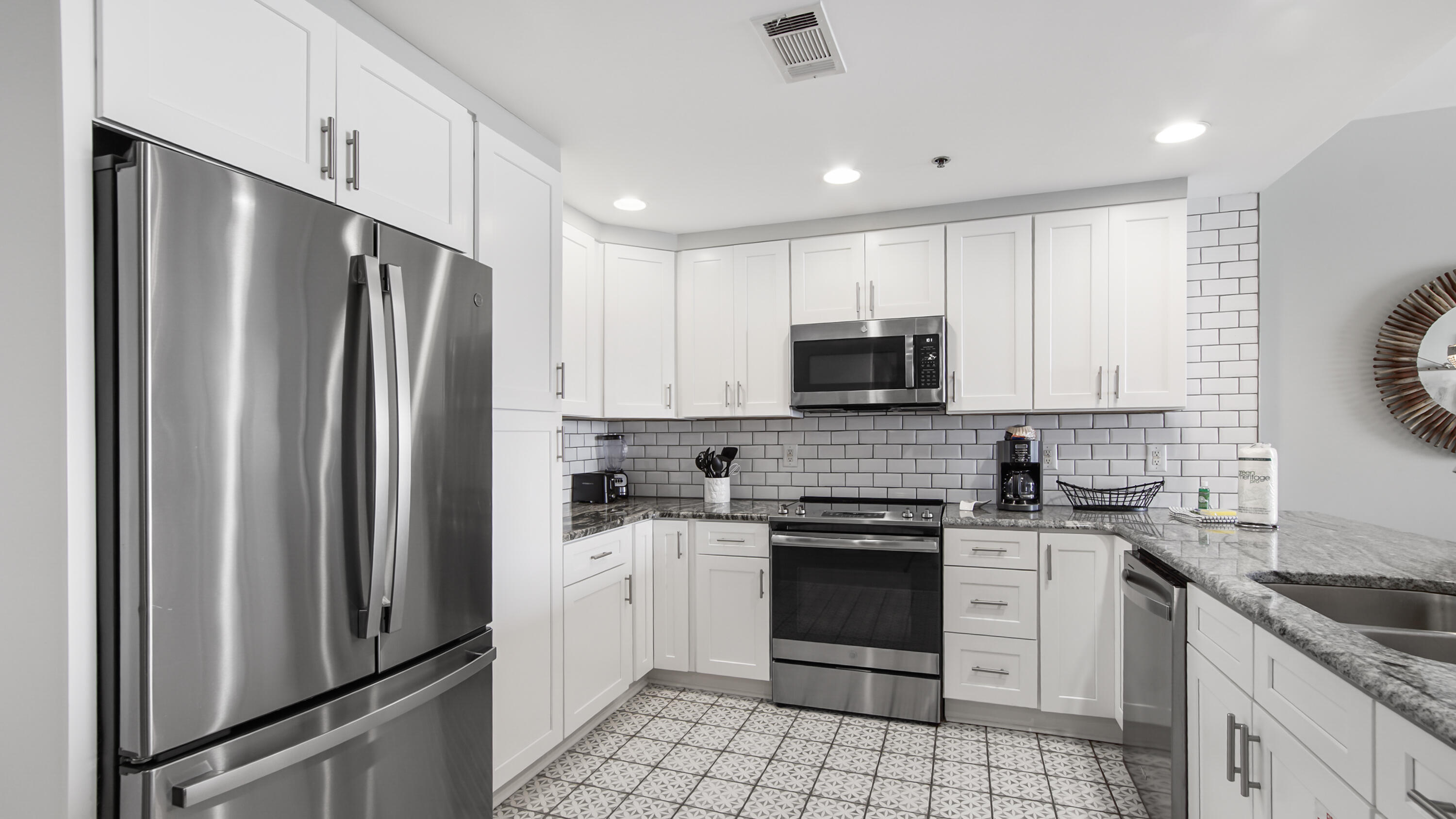 17739 Front Beach Road, Unit 507W Panama City Beach, FL 32413 - Photo 3 of 49 a kitchen with a sink stove and refrigerator
