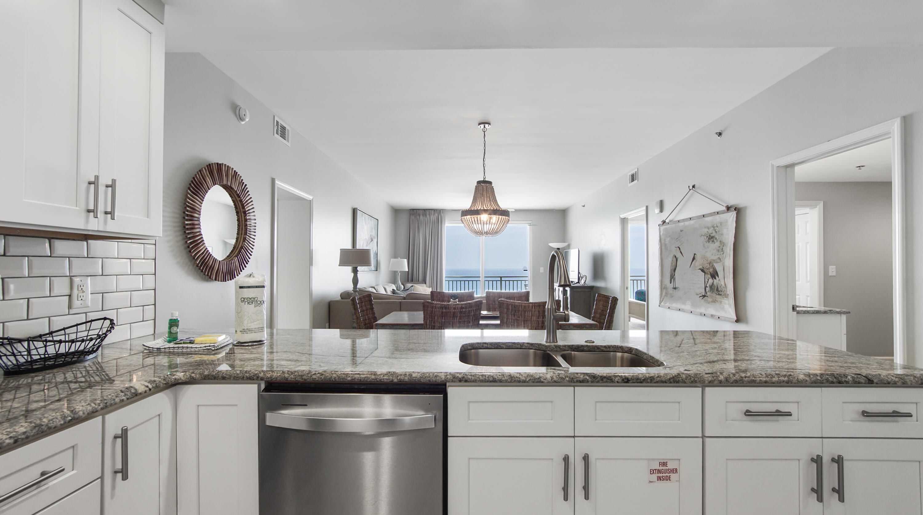 17739 Front Beach Road, Unit 507W Panama City Beach, FL 32413 - Photo 5 of 49 a kitchen with granite countertop a sink and cabinets