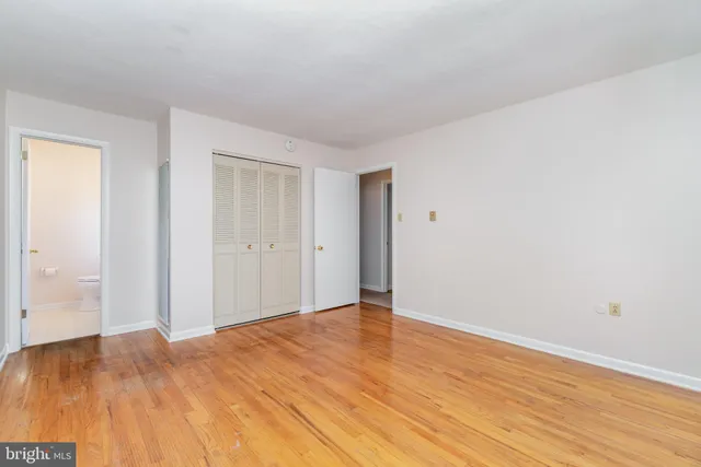 a view of an empty room and wooden floor