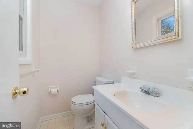 a white toilet sitting next to a bathroom sink