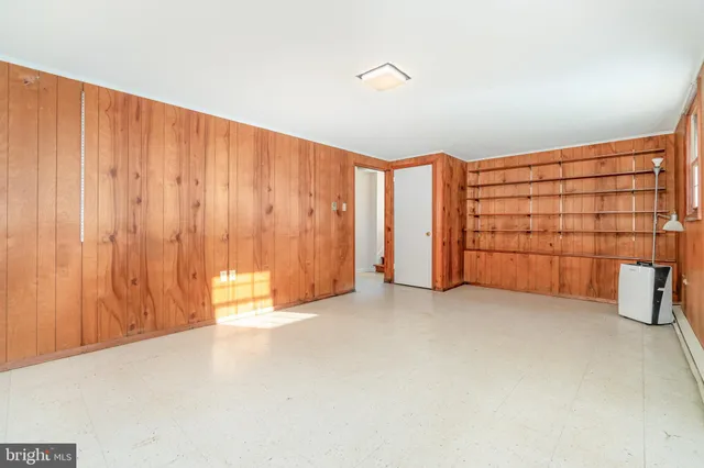 an empty room with a empty space and windows