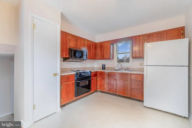 a kitchen with stainless steel appliances granite countertop a refrigerator stove top oven a sink and dishwasher