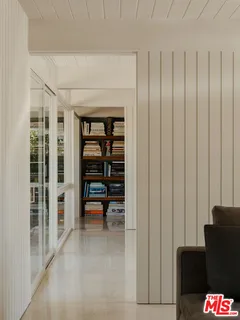 a living room with couches a coffee table and a large window with outer view