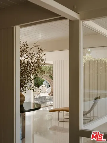 a view of a balcony with chair and the potted plant