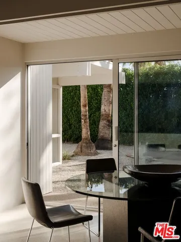 a living room with furniture and a floor to ceiling window