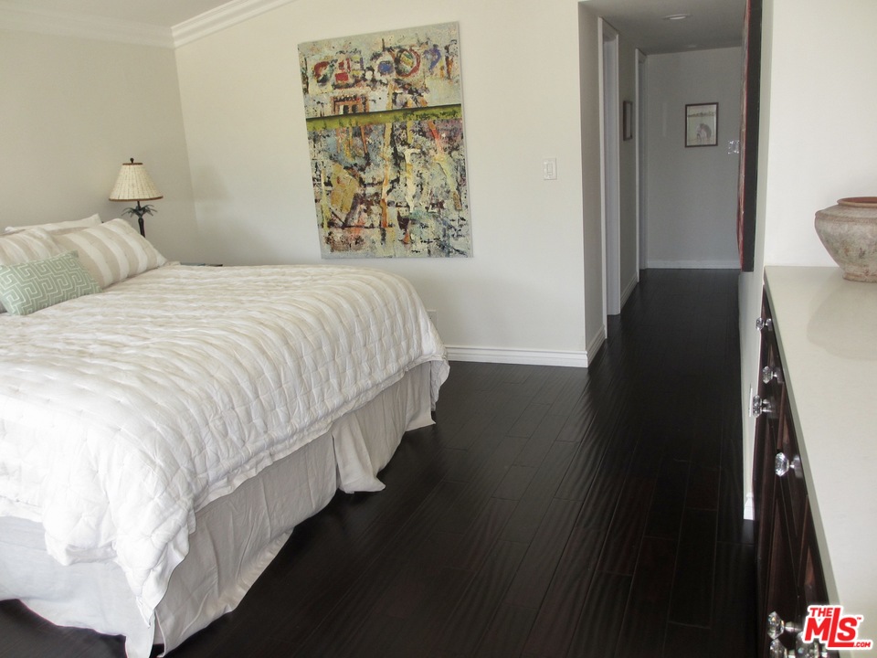 3641 Surfwood Road Malibu, CA 90265 - Photo 12 of 29 a bedroom with a bed and a painting on the wall