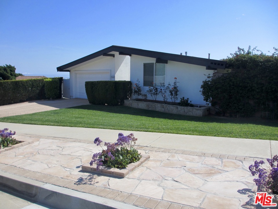 3641 Surfwood Road Malibu, CA 90265 - Photo 2 of 29 a front view of a house with garden