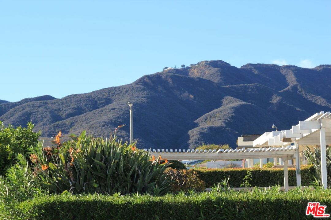 3641 Surfwood Road Malibu, CA 90265 - Photo 22 of 29 a view of a large building with a mountain in the background