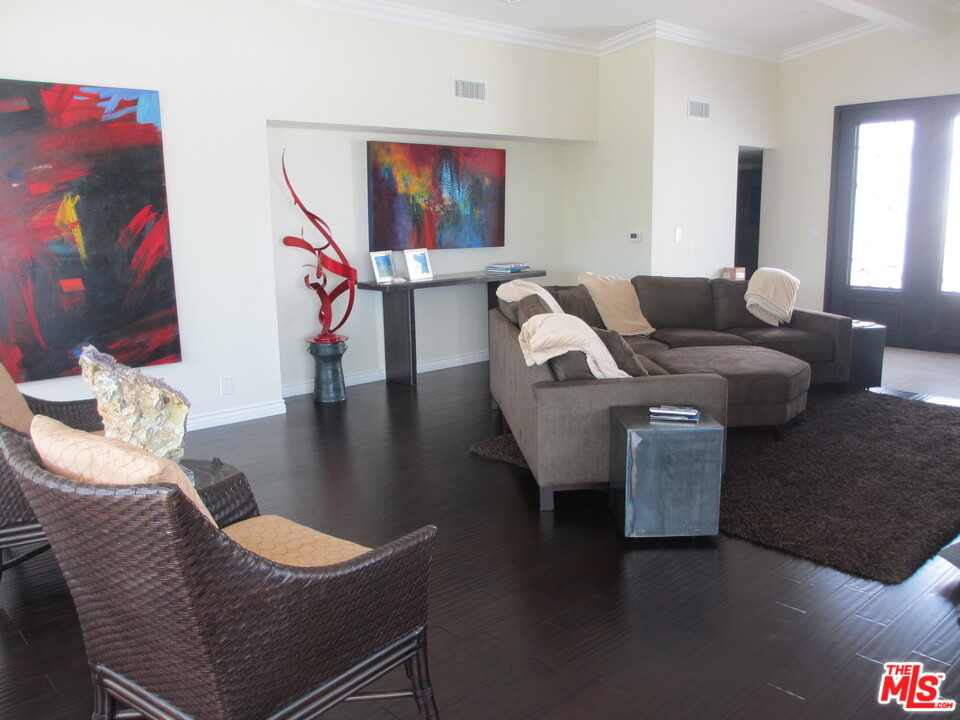 3641 Surfwood Road Malibu, CA 90265 - Photo 10 of 29 a living room with furniture and wooden floor
