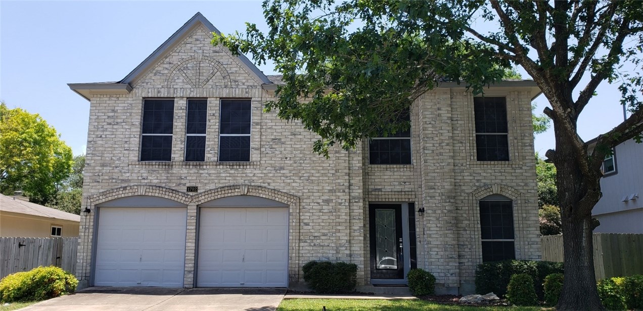 a front view of a house with brick walls