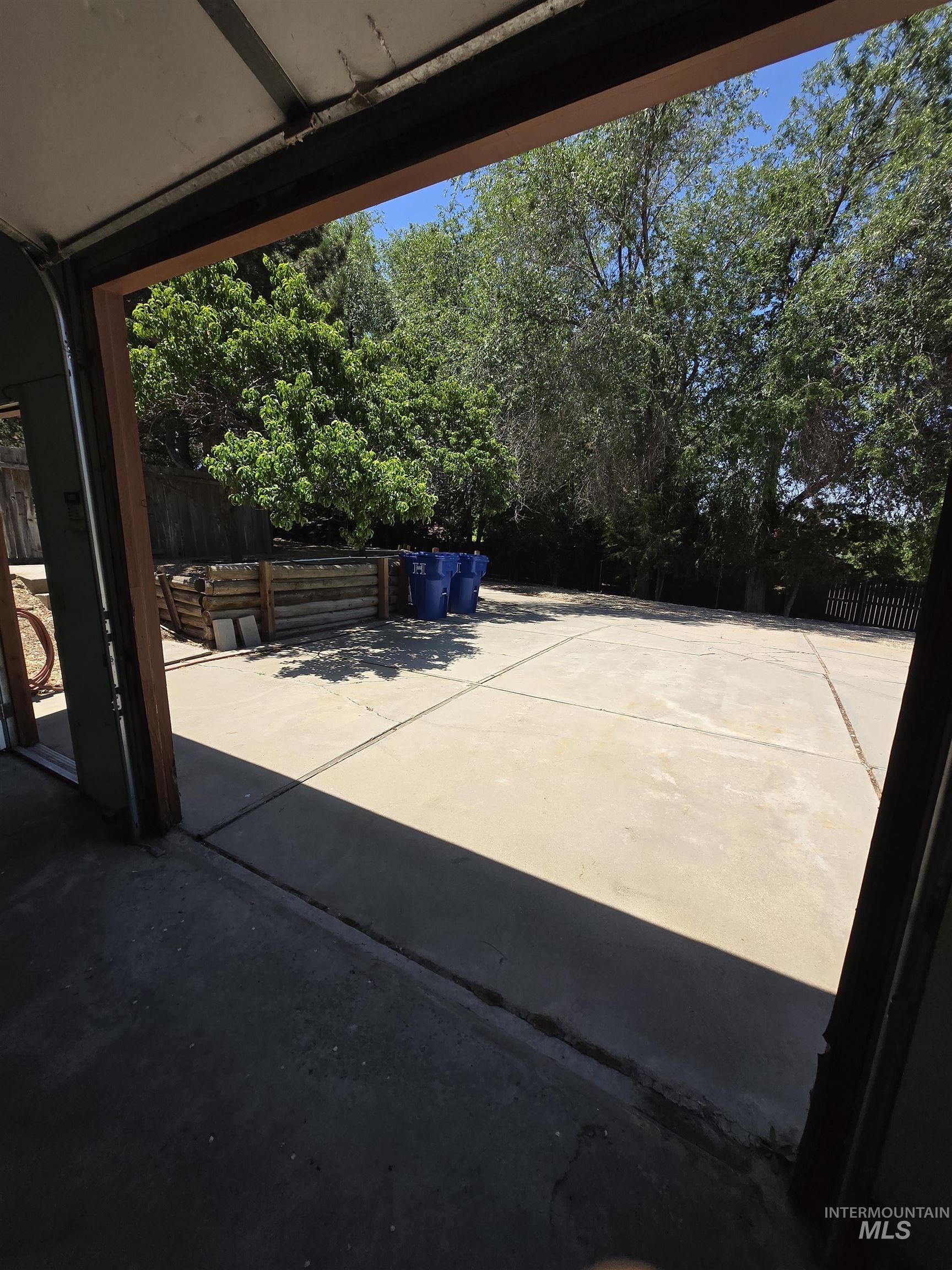 12050 West Hidden Valley Rim Road Boise, ID 83709 - Photo 25 of 39 Expansive concrete patio with mature trees providing natural shade