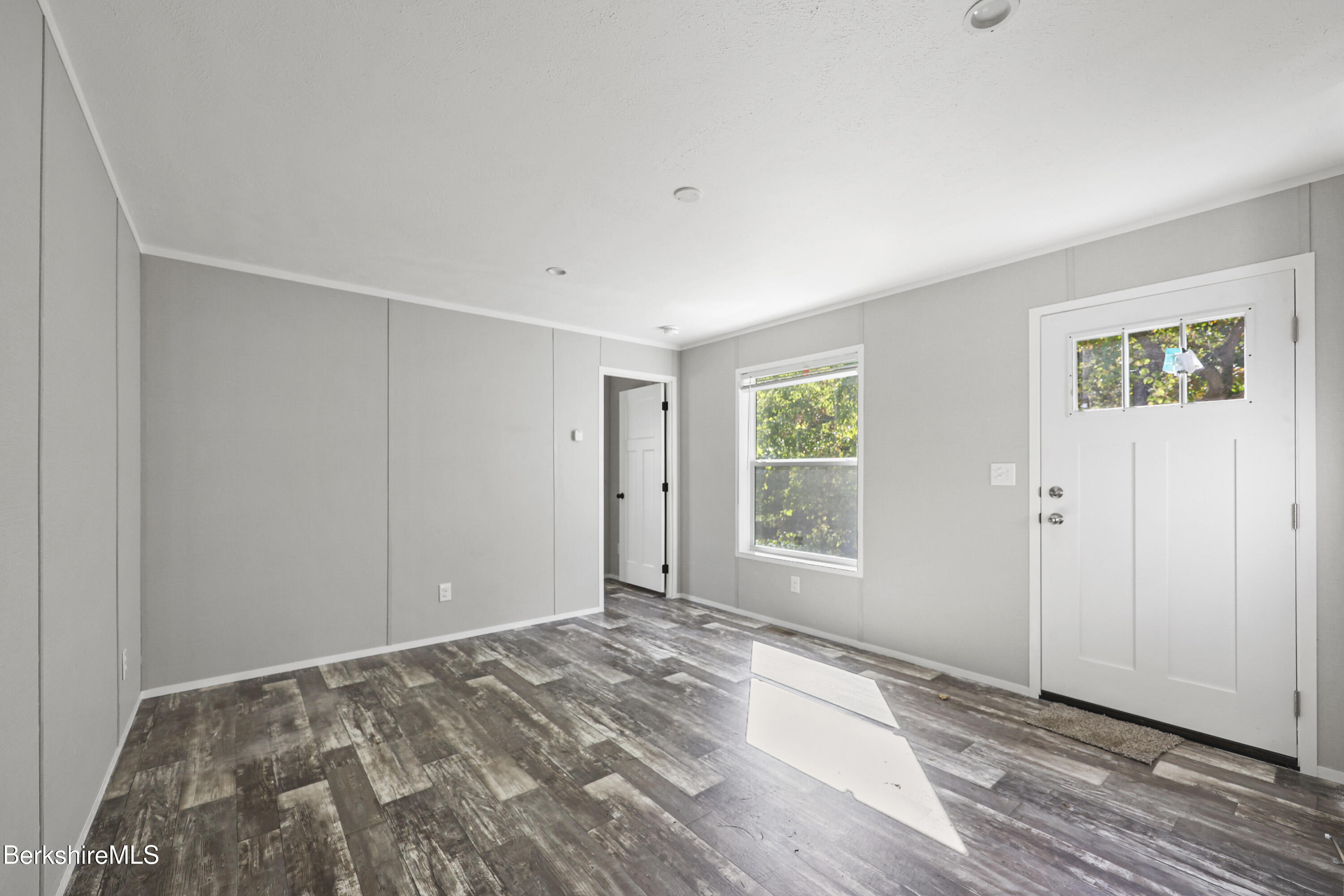 12 Aztec Drive North Adams, MA 01247 - Photo 3 of 14 a view of empty room with wooden floor and fan