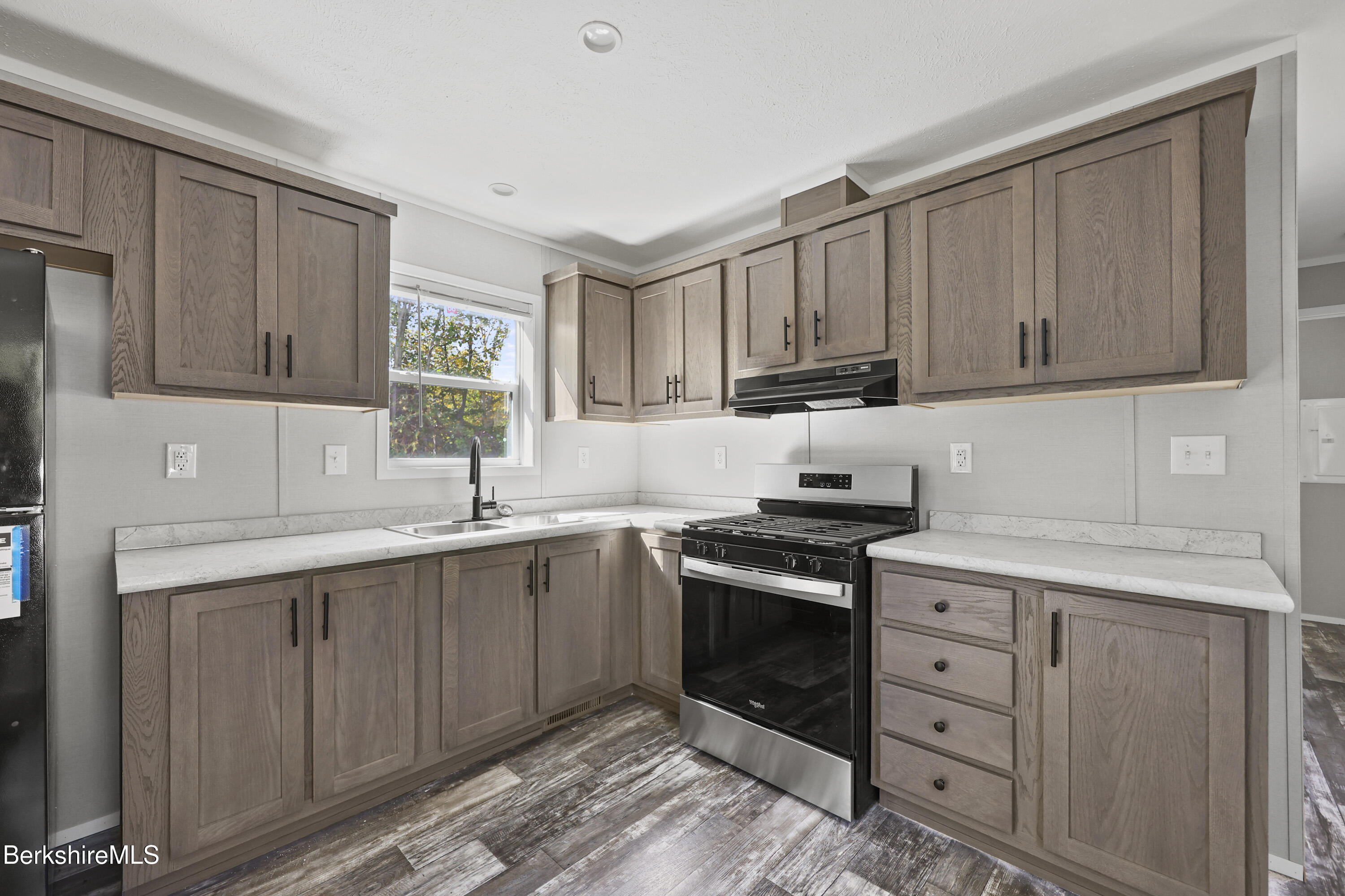 12 Aztec Drive North Adams, MA 01247 - Photo 7 of 14 a kitchen with cabinets appliances a sink and a window