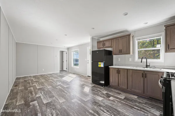 a kitchen with a refrigerator a sink and a window