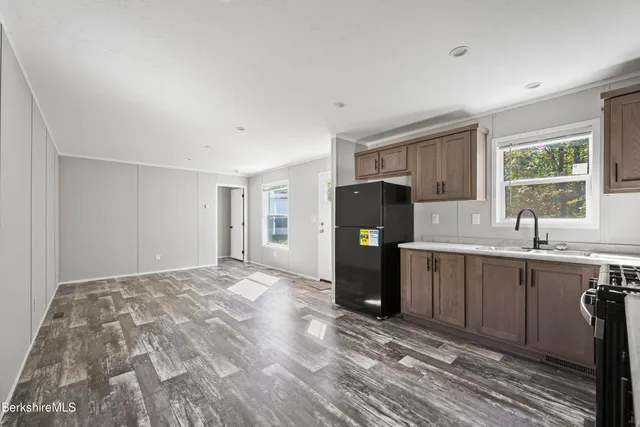a kitchen with a refrigerator a sink and a window
