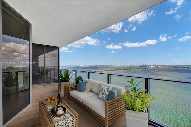 a living room with furniture and a floor to ceiling window