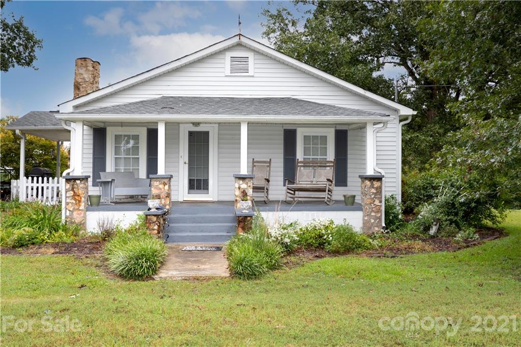 4551 River Road Smyrna, SC 29743 - Photo 3 of 19 a front view of a house with porch and garden