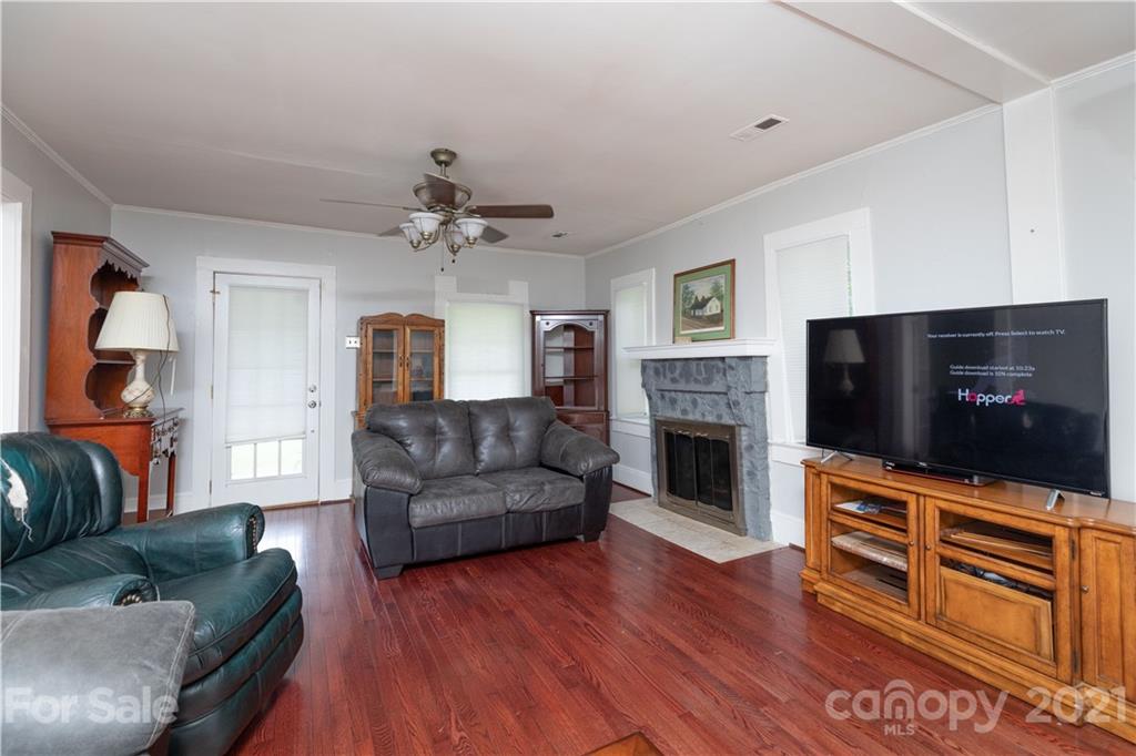 4551 River Road Smyrna, SC 29743 - Photo 5 of 19 a living room with furniture a flat screen tv and a fireplace