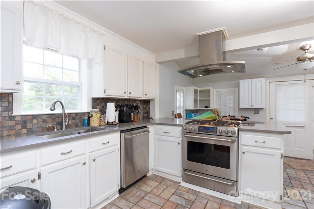 4551 River Road Smyrna, SC 29743 - Photo 6 of 19 a kitchen with stainless steel appliances granite countertop a sink a stove and a window