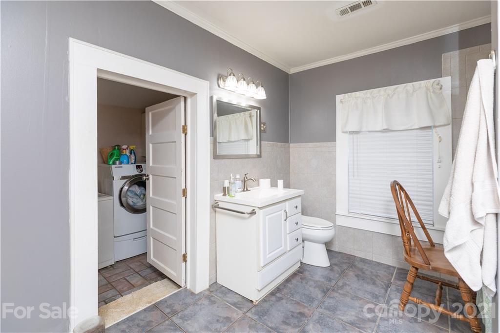 4551 River Road Smyrna, SC 29743 - Photo 9 of 19 a bathroom with a toilet a sink and a mirror