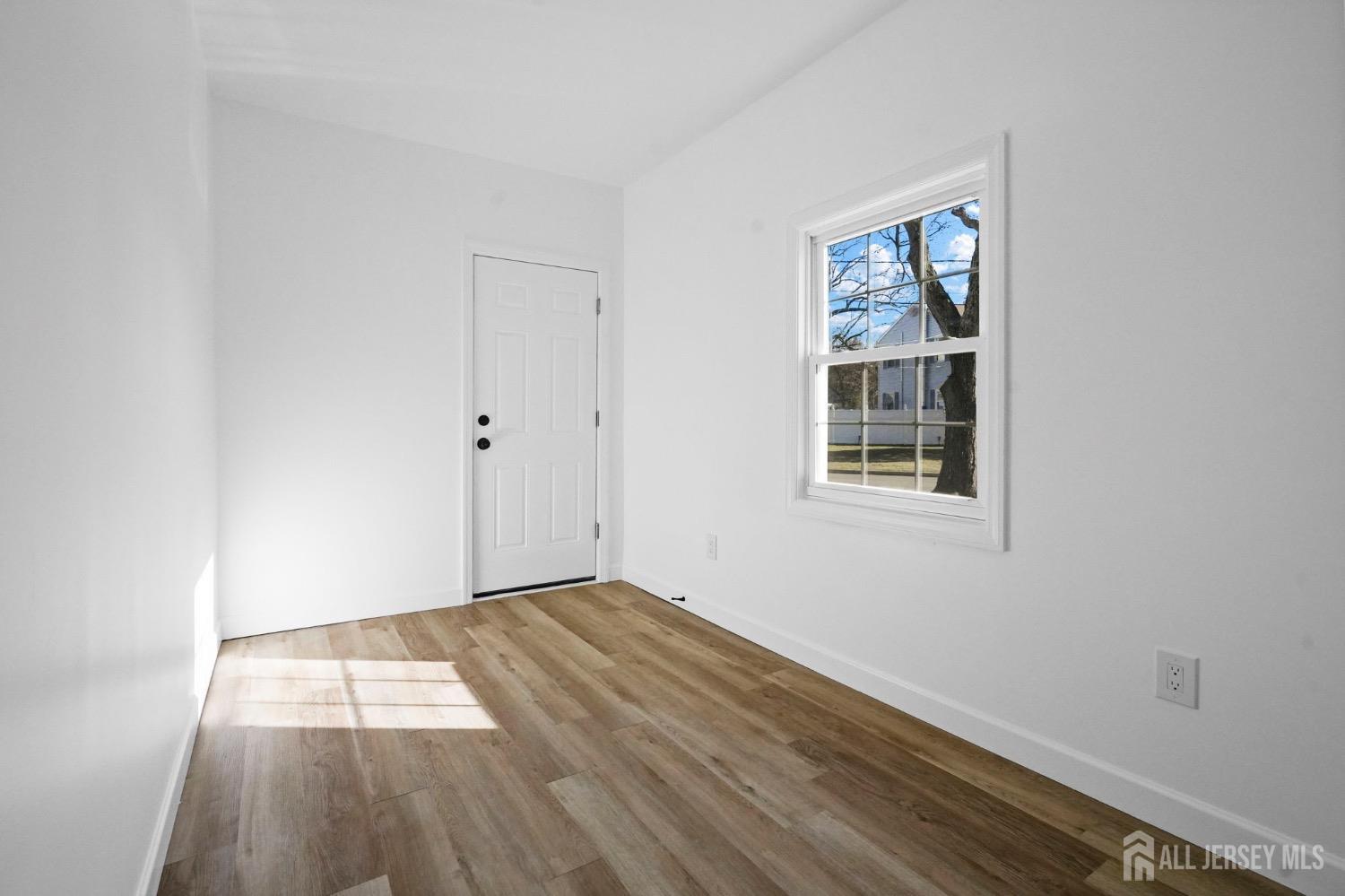 32 Nelson Circle East Brunswick, NJ 08816 - Photo 13 of 35 an empty room with wooden floor and windows