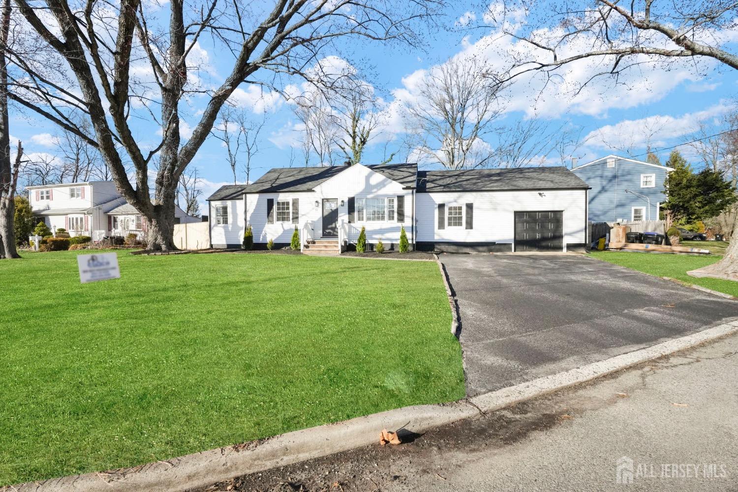 32 Nelson Circle East Brunswick, NJ 08816 - Photo 30 of 35 a front view of a house with a yard and trees