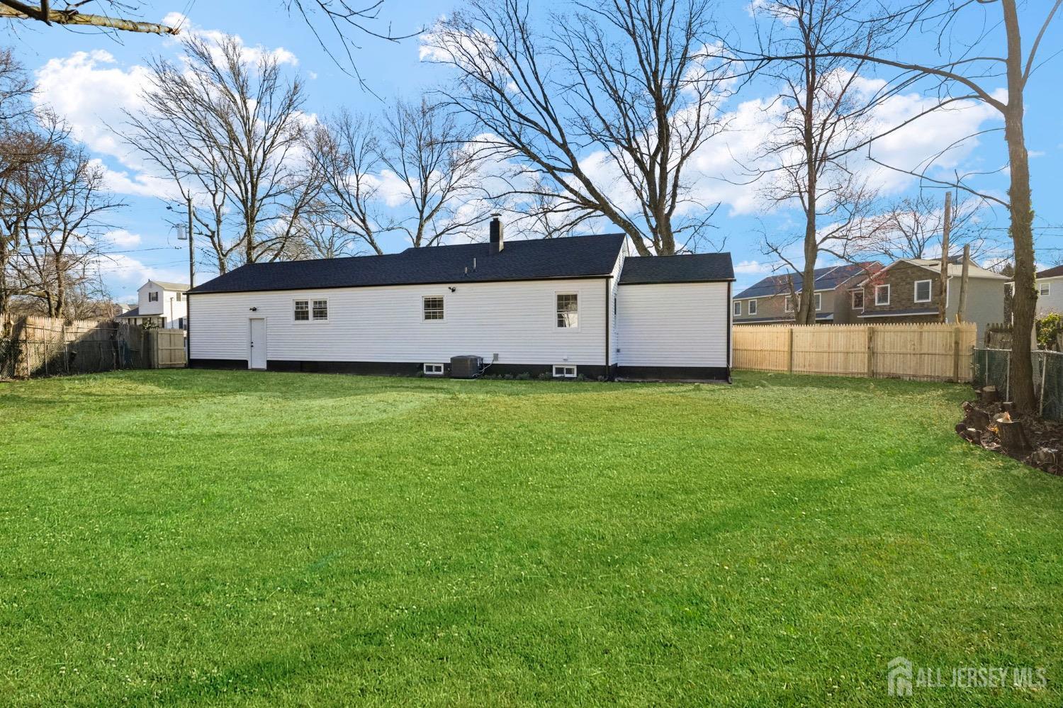 32 Nelson Circle East Brunswick, NJ 08816 - Photo 32 of 35 a white house that has a big yard with wooden fence