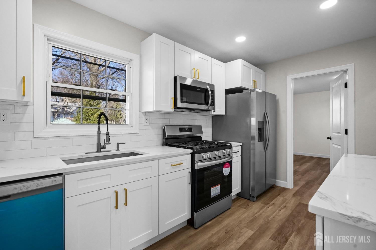 32 Nelson Circle East Brunswick, NJ 08816 - Photo 8 of 35 a kitchen with a stove a sink and a refrigerator