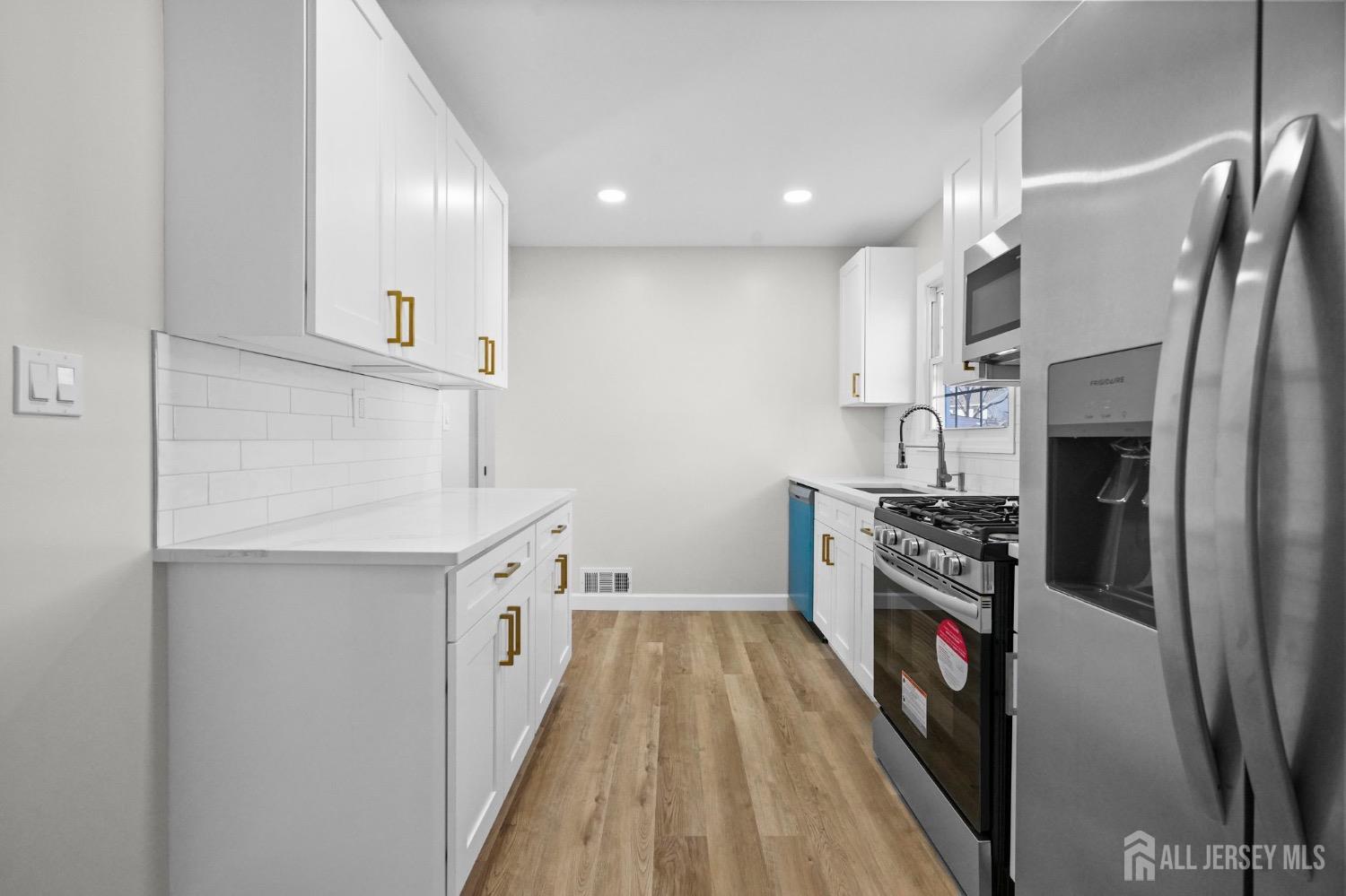 32 Nelson Circle East Brunswick, NJ 08816 - Photo 10 of 35 a kitchen with stainless steel appliances granite countertop a refrigerator a stove and a sink