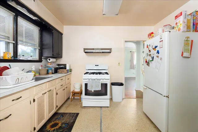 a kitchen with stainless steel appliances a refrigerator sink and stove