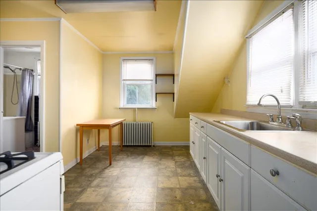 a bathroom with a double vanity sink a mirror and a bathtub