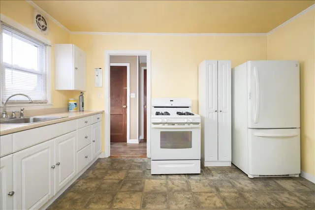a kitchen with a refrigerator sink and stove