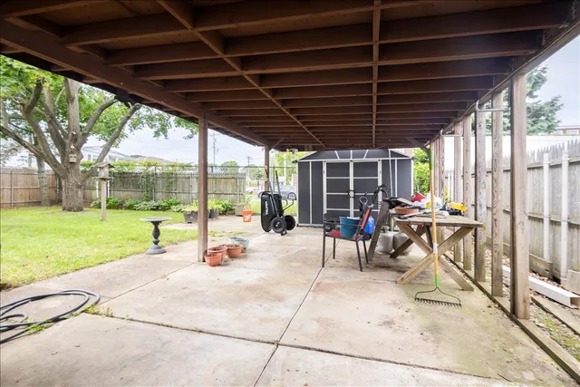 a view of a backyard with table and chairs and potted plants