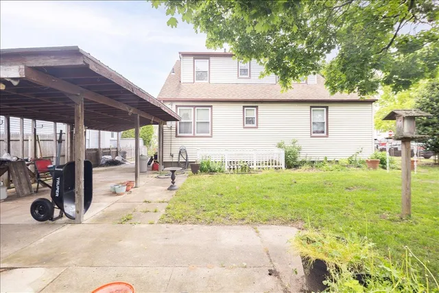 a backyard of a house with table and chairs
