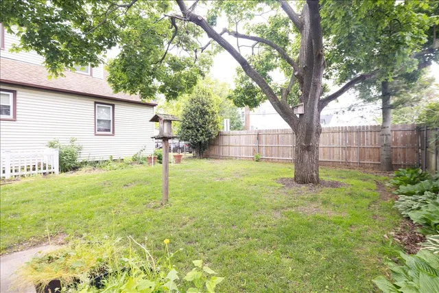 a view of a house with a yard and sitting area