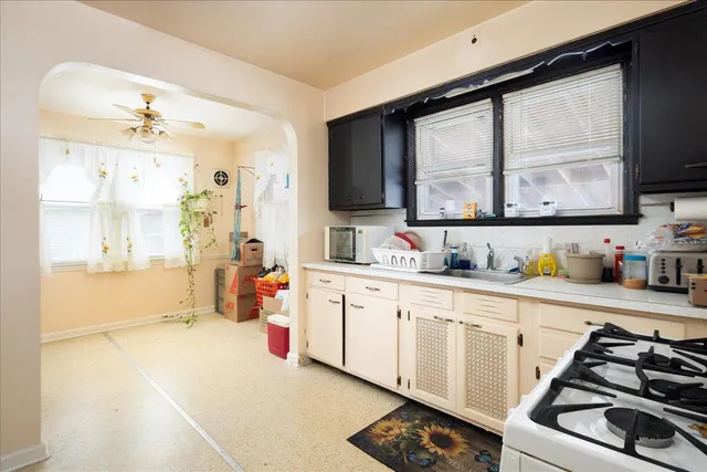 a kitchen with stainless steel appliances a sink stove and cabinets