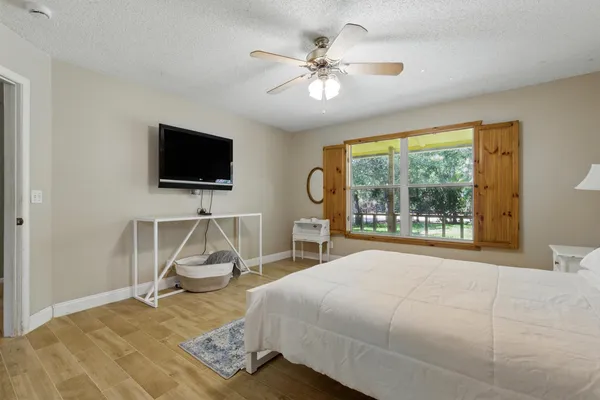 a bedroom with a bed and a flat screen tv