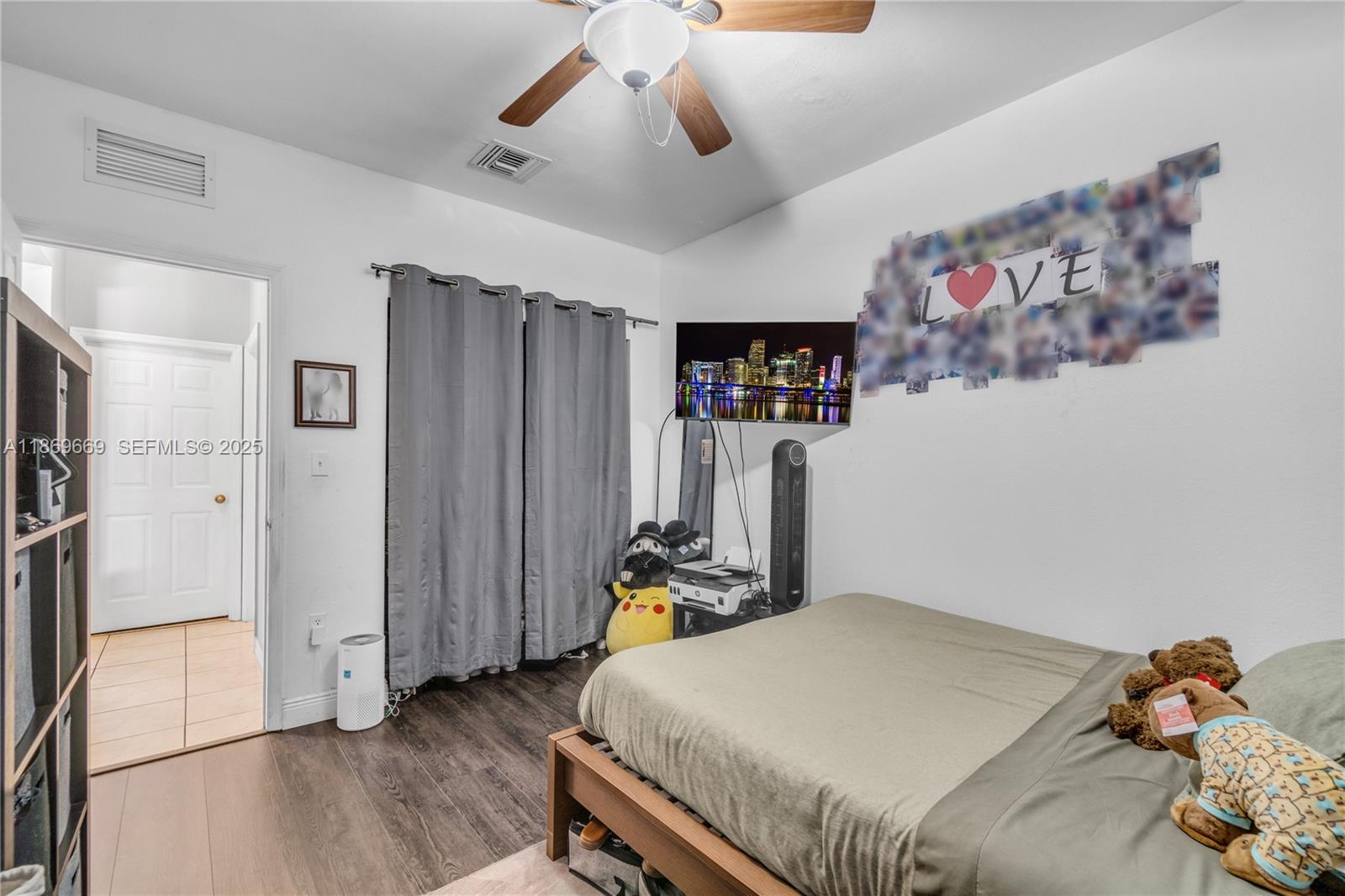 120 Southeast 6th Road Homestead, FL 33030 - Photo 13 of 31 a bedroom with a bed and wooden floor