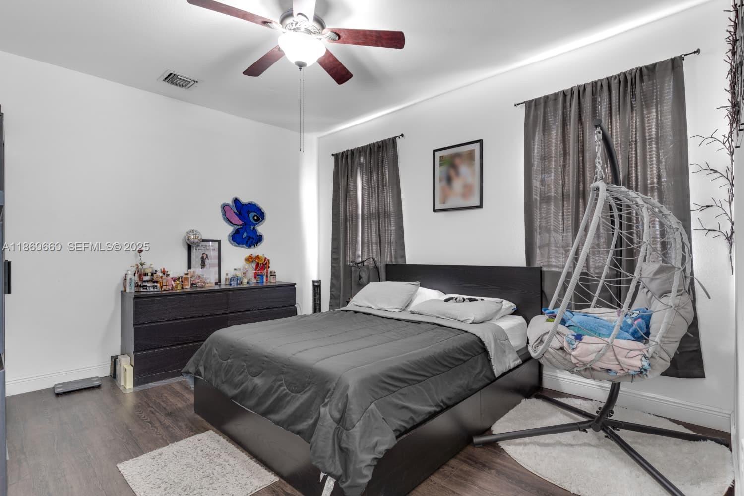 120 Southeast 6th Road Homestead, FL 33030 - Photo 15 of 31 a bedroom with a bed and wooden floor