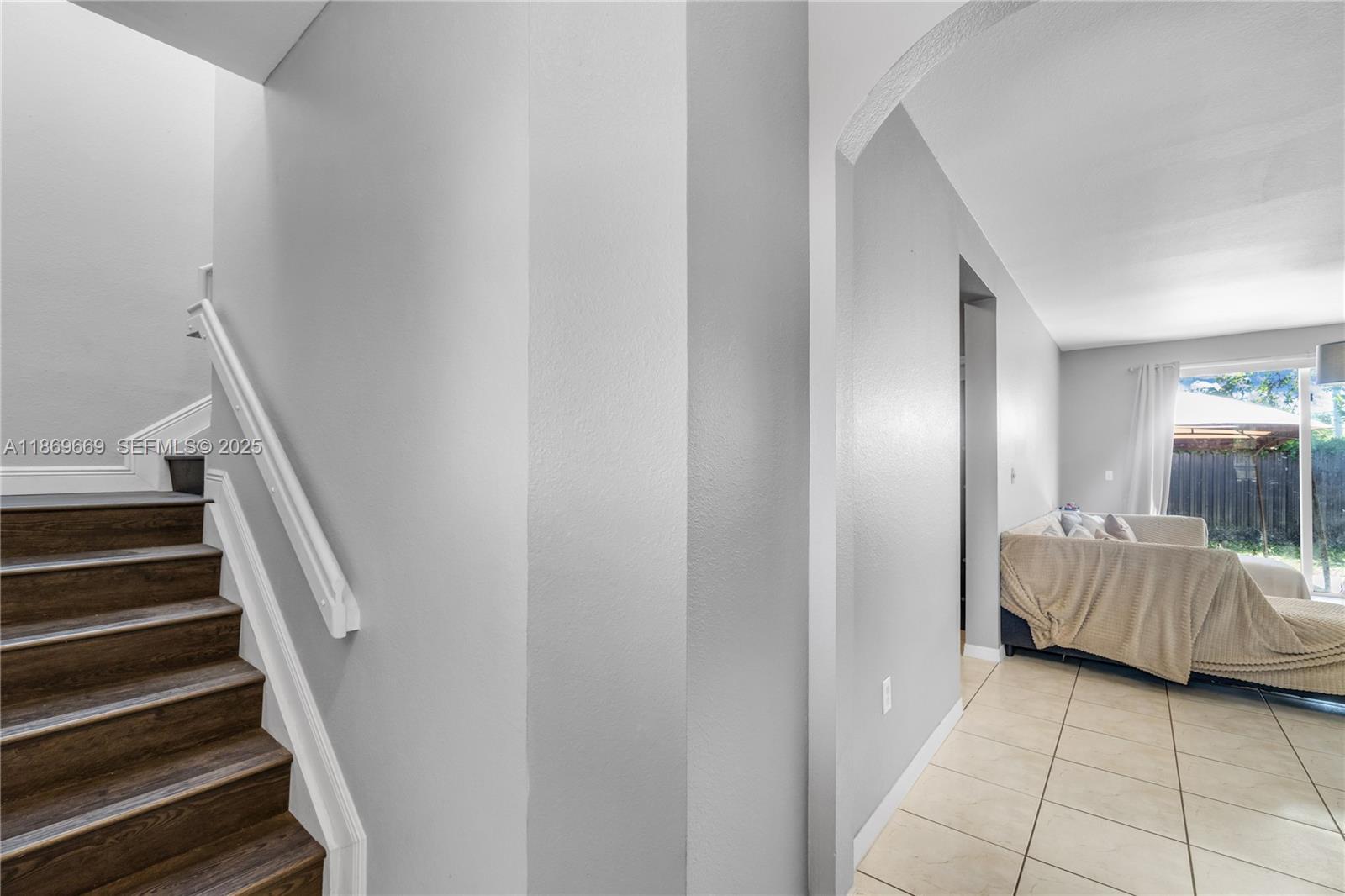 120 Southeast 6th Road Homestead, FL 33030 - Photo 4 of 31 a view of a bedroom with wooden floor and stairs