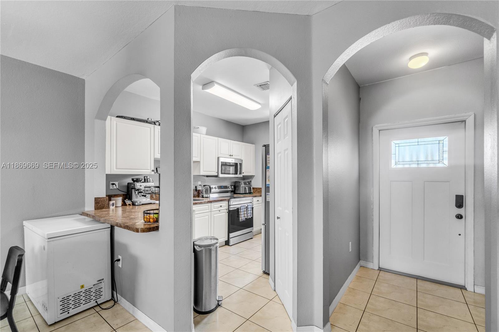 120 Southeast 6th Road Homestead, FL 33030 - Photo 6 of 31 a kitchen with refrigerator and cabinets