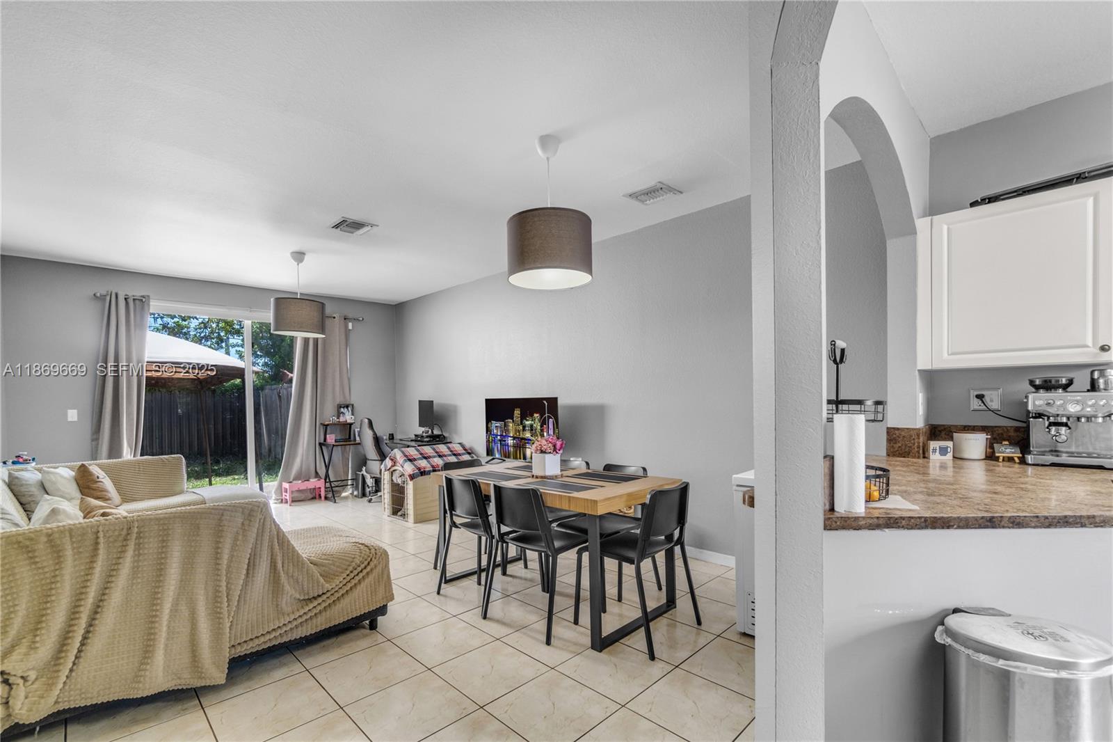 120 Southeast 6th Road Homestead, FL 33030 - Photo 8 of 31 a living room with furniture and a large window