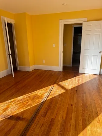 a view of a room with wooden floor and a balcony