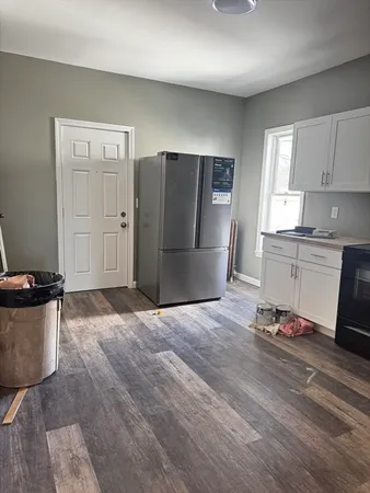 a kitchen with stainless steel appliances granite countertop a refrigerator and a stove top oven